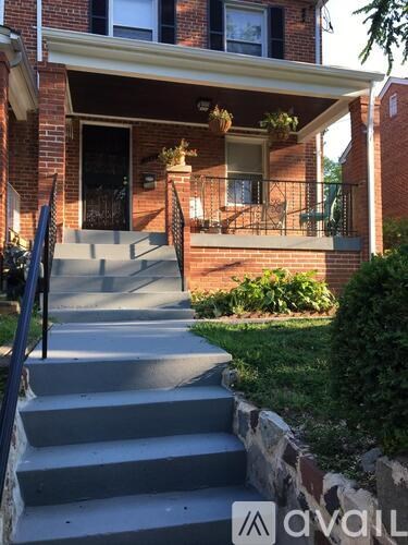 A house with a front porch and stairs leading up to it.