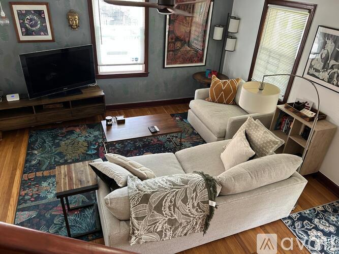 A living room with a grey couch and a wooden coffee table.