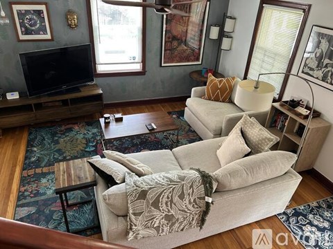 A living room with a grey couch and a wooden coffee table.