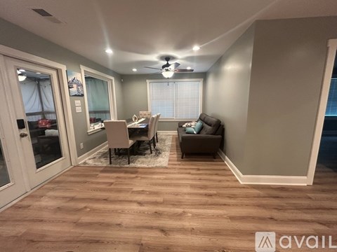 A living room with a dining table and chairs.