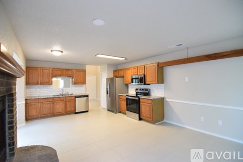 A kitchen with wooden cabinets and a black stove top oven.