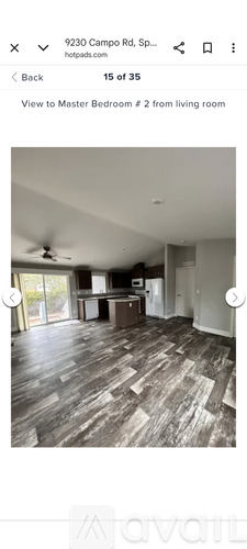 A room with wooden flooring and a ceiling fan.
