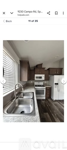 A kitchen with a sink, stove, and refrigerator.