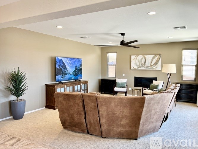 A spacious living room with a carpeted floor and a white ceiling.