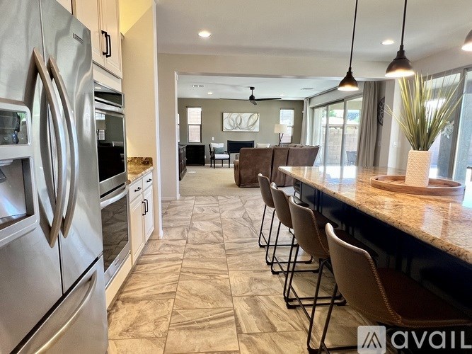 A square planter with soil in the middle is surrounded by a brick patterned floor.