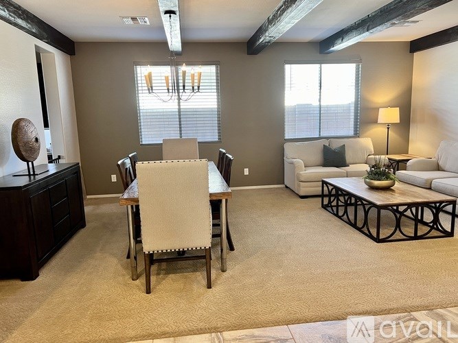 A living room with a dining table and chairs.