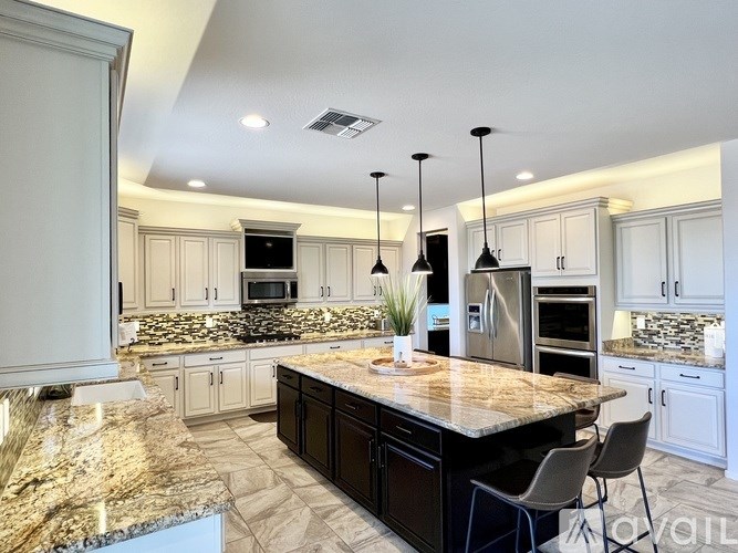 A living room with a wooden table and white chairs.