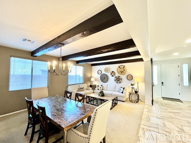 A living room with a white couch, a coffee table, and a painting on the wall.
