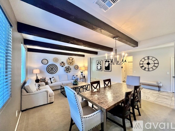 A dining room with a wooden table and chairs.