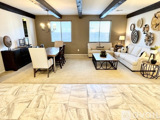 A living room with a dining table and chairs.