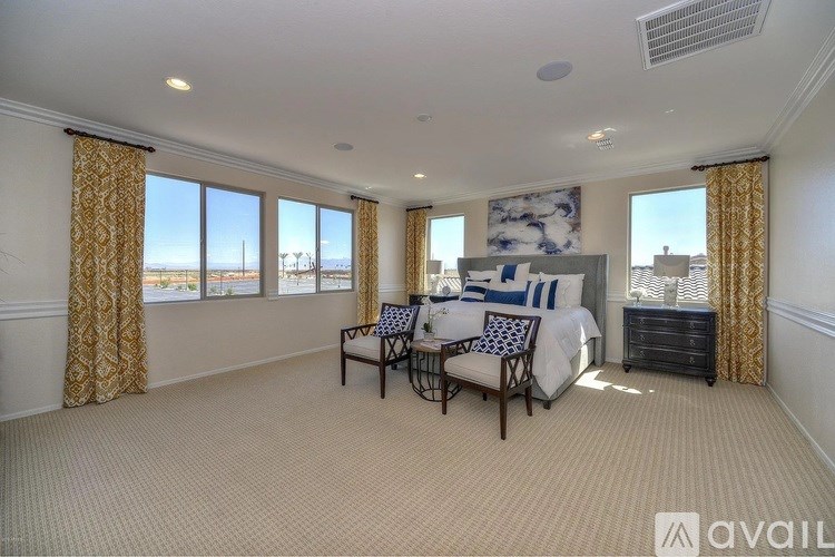 A room with a yellow door, a black table, and a television mounted on the wall.