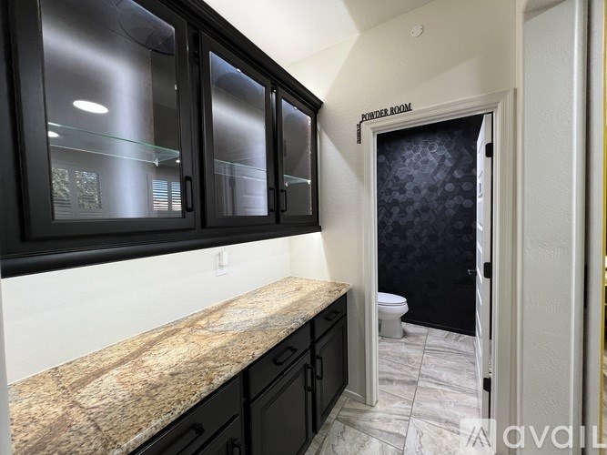 A bathroom with a marble countertop and a shower room.