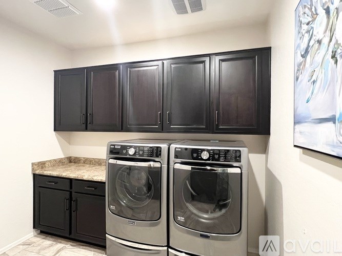 A bathroom with a walk-in shower, double sinks, and a large mirror.