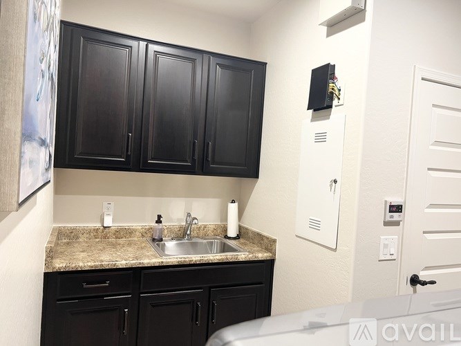 A bathroom with a walk-in shower, double sinks, and a large mirror.