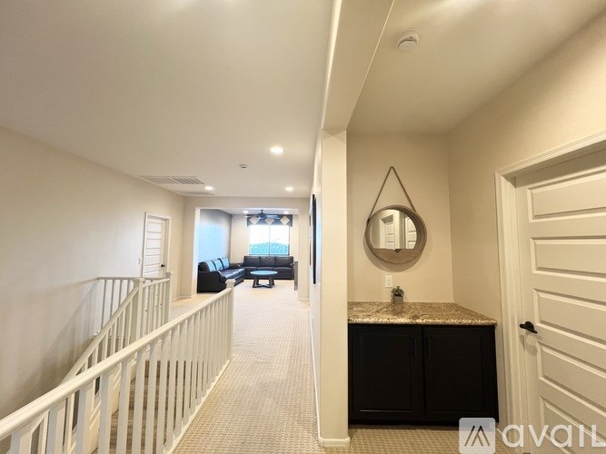 A walk-in closet with white shelves and drawers.