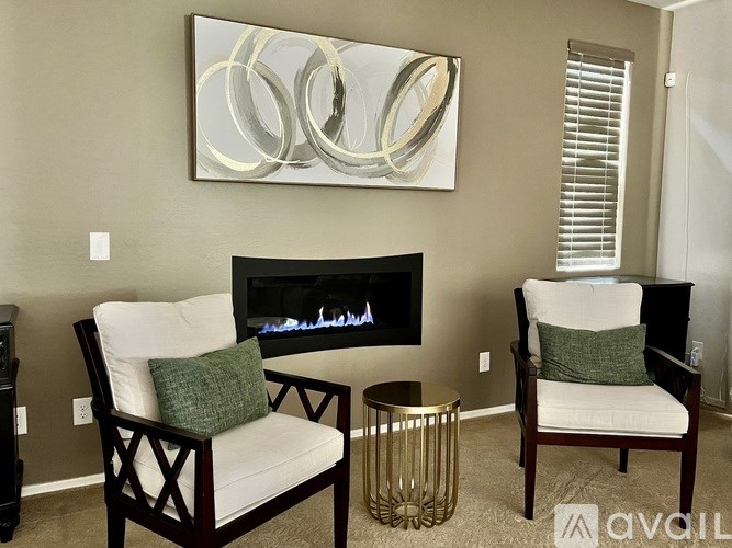 A pool with a red umbrella and yellow chairs.