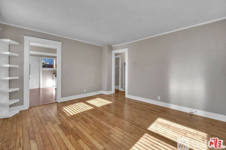 A room with wooden floors and white walls.