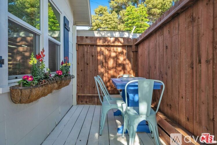 A small patio with a table and chairs.
