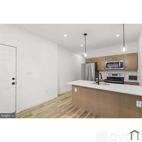 A kitchen with wooden cabinets and a white countertop.