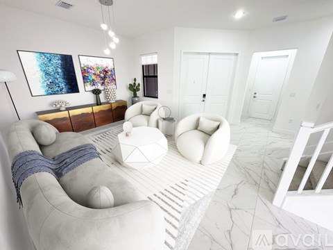A modern living room with a white sofa and a wooden sideboard.