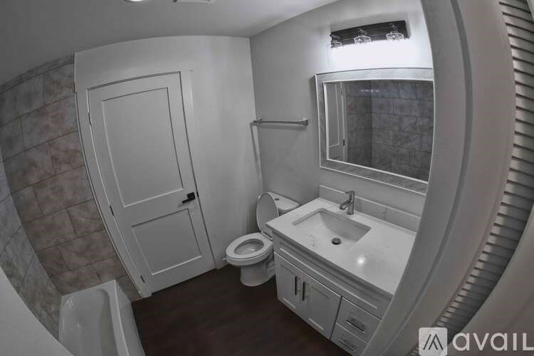 A bathroom with a toilet, sink, and tub.