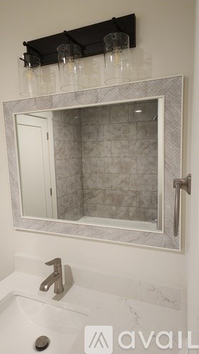 A room with wooden floors and a black door.