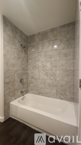 A bathroom with a toilet, sink, and mirror.