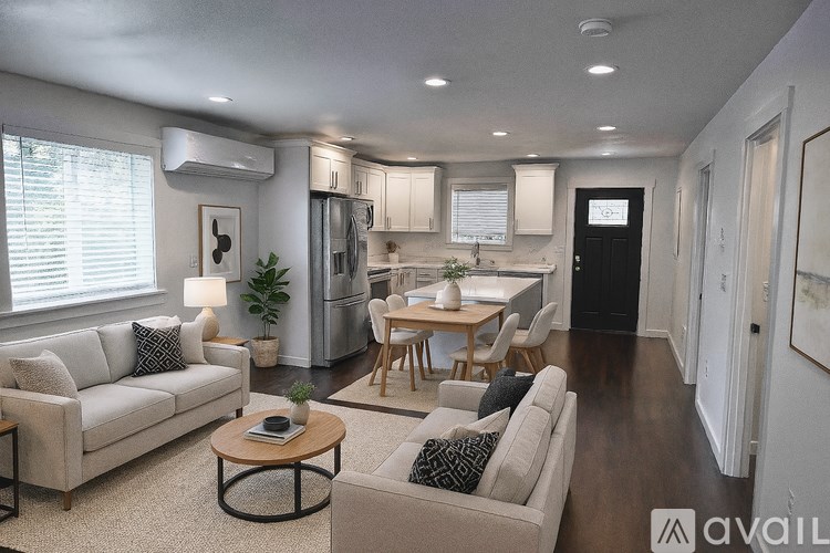 A modern kitchen with stainless steel appliances and white cabinets.