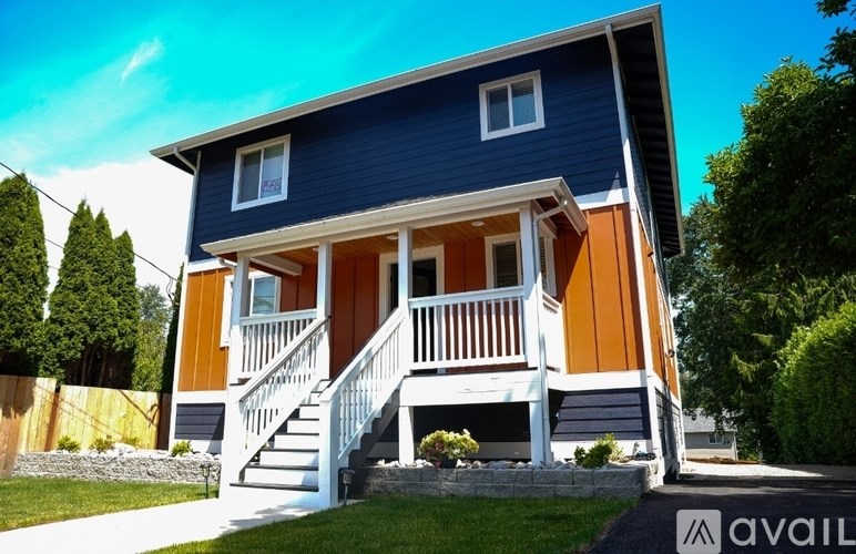 A modern kitchen with stainless steel appliances and white cabinets.