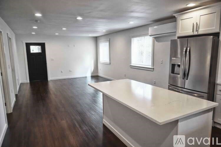 A kitchen with a white countertop and stainless steel appliances.