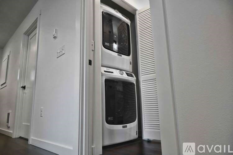 A modern kitchen with a white oven and cabinets.