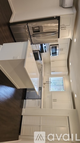 A kitchen with a stainless steel refrigerator, oven, and cabinets.