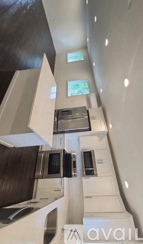 A modern kitchen with a stove, oven, microwave, and sink.