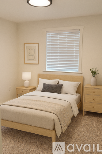 A bedroom with a bed, nightstand, and window.