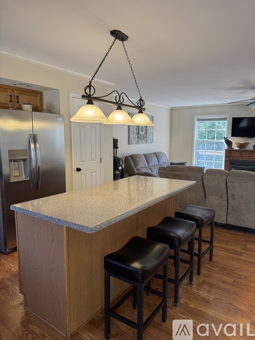 A kitchen with a bar and stools.