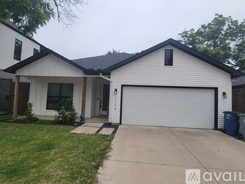 A two-story house with a white garage door.