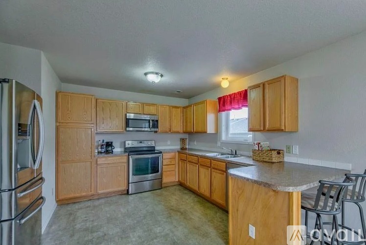 A kitchen with wooden cabinets and stainless steel appliances.