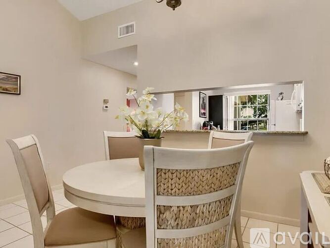 A dining room with a round table and chairs.