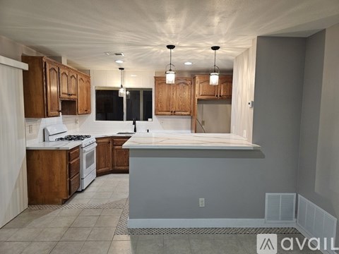 A kitchen with wooden cabinets and a white countertop.
