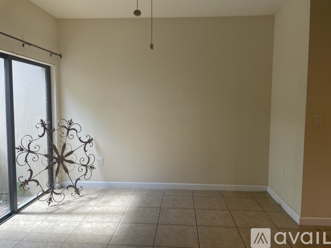 A room with a sliding glass door and a decorative window grille.