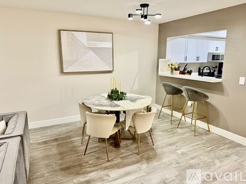 A dining room with a round table and chairs.