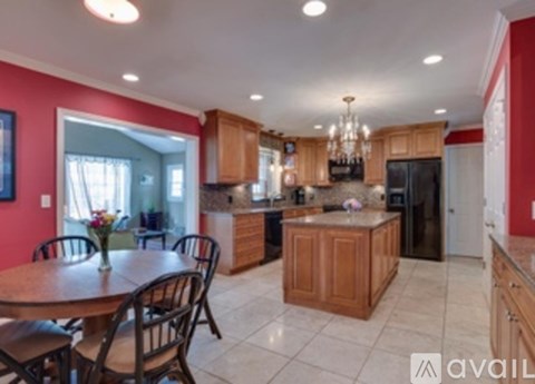 A kitchen with a table and chairs in the middle of the room.