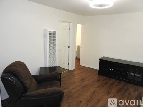A living room with a brown leather chair and a black coffee table.