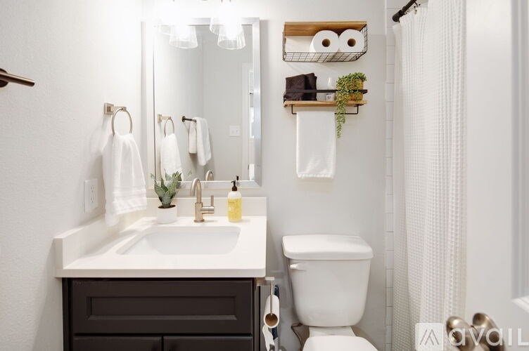 A white sink and toilet in a bathroom.