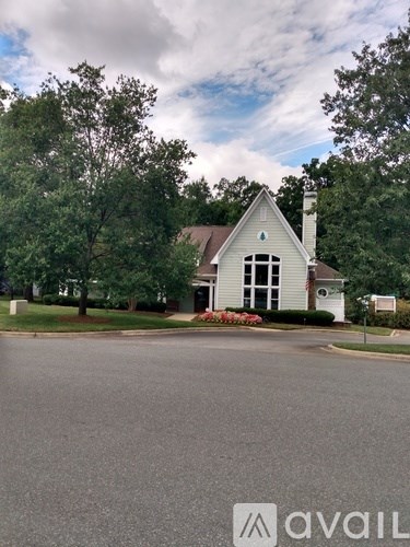 A house with a white front yard and a tree in front of it.