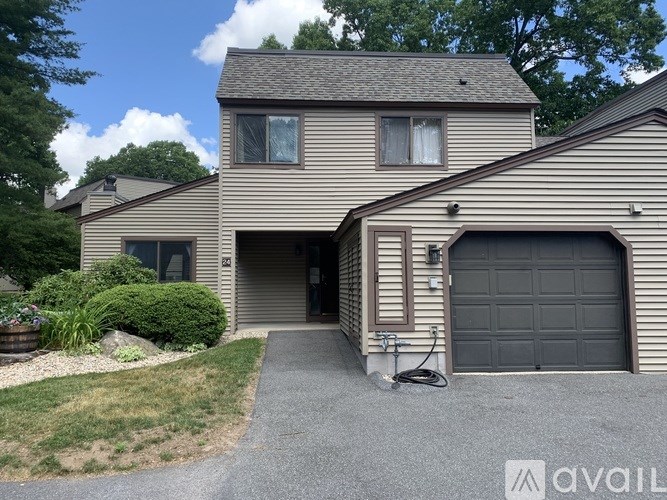 A two-story house with a garage is available for rent.
