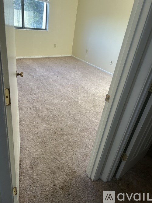 A house with a grey roof and a white garage door.