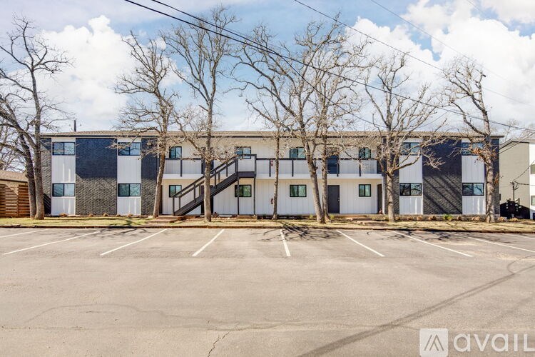 A large industrial building with a parking lot in front.