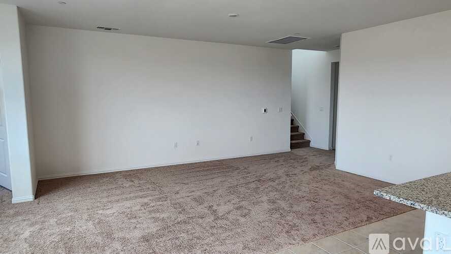 A room with a carpeted floor and white walls.