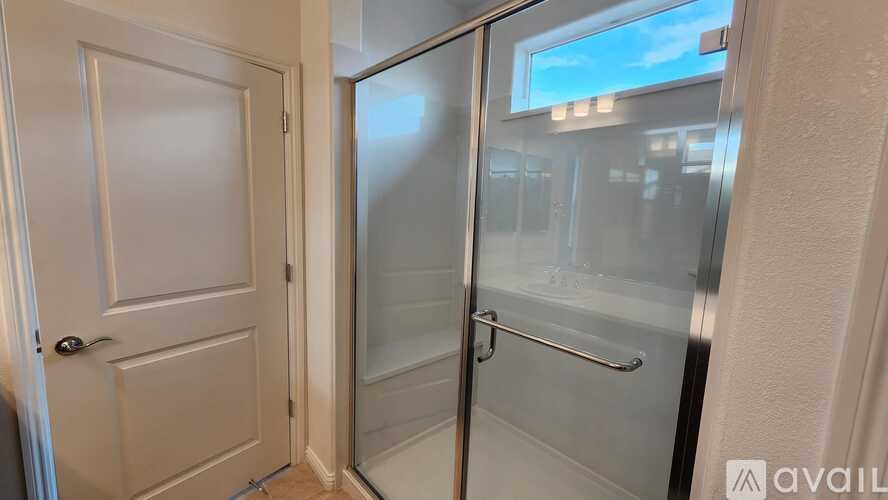 A white door with a glass window is open.